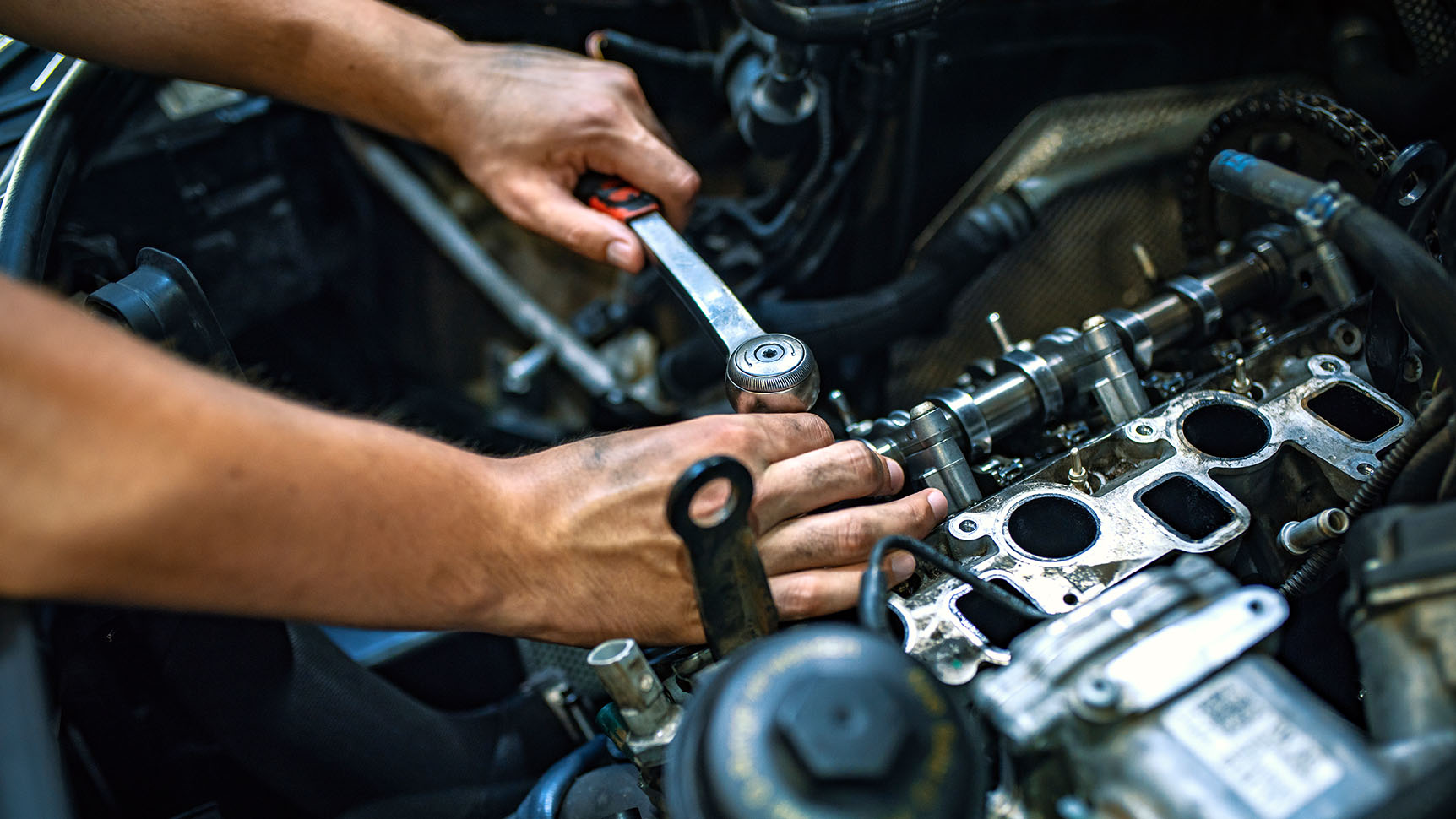 Mechanic using a ratchet wrench Mechanic using a ratchet wrench